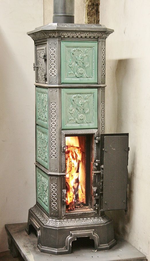 Freestanding tiled stove refurbished as a standard stove with double fire door and glass door