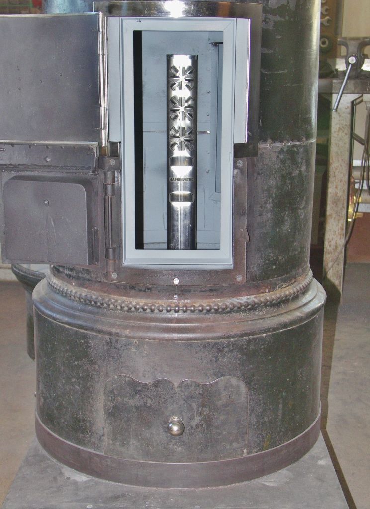 Refurbishment of a cylindrical stove with external fresh air supply through a fresh air column - Perler Ofen GmbH