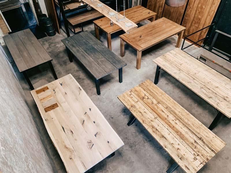 Eine Gruppe von Holztischen und Bänken in einem Raum.