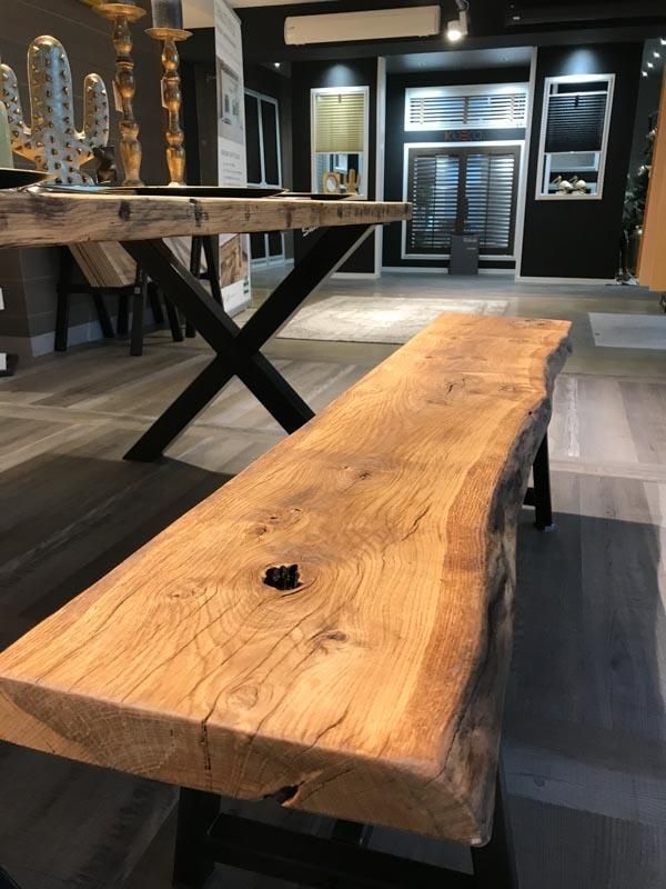 Eine Holzbank in einem Raum neben einem Tisch