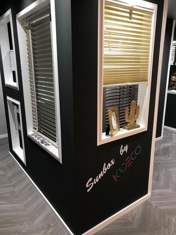 Ein Raum mit vielen Fenstern und Jalousien an der Wand.