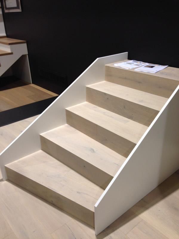 Eine Reihe von Holztreppen mit einem weißen Geländer