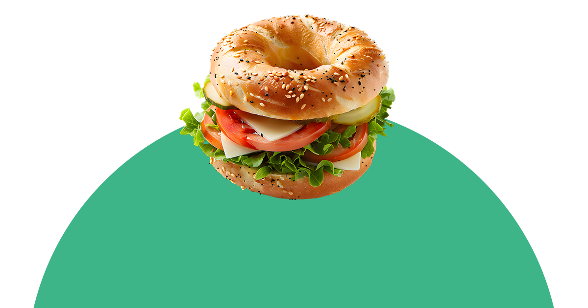 Ein Bagel-Sandwich mit Salat, Tomaten und Käse auf einem grünen Kreis.