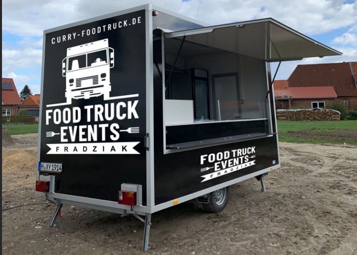 Ein Imbisswagen steht auf einem Feld.