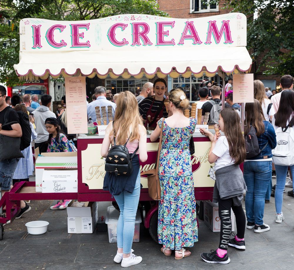Eine Gruppe von Menschen steht vor einem Eisstand