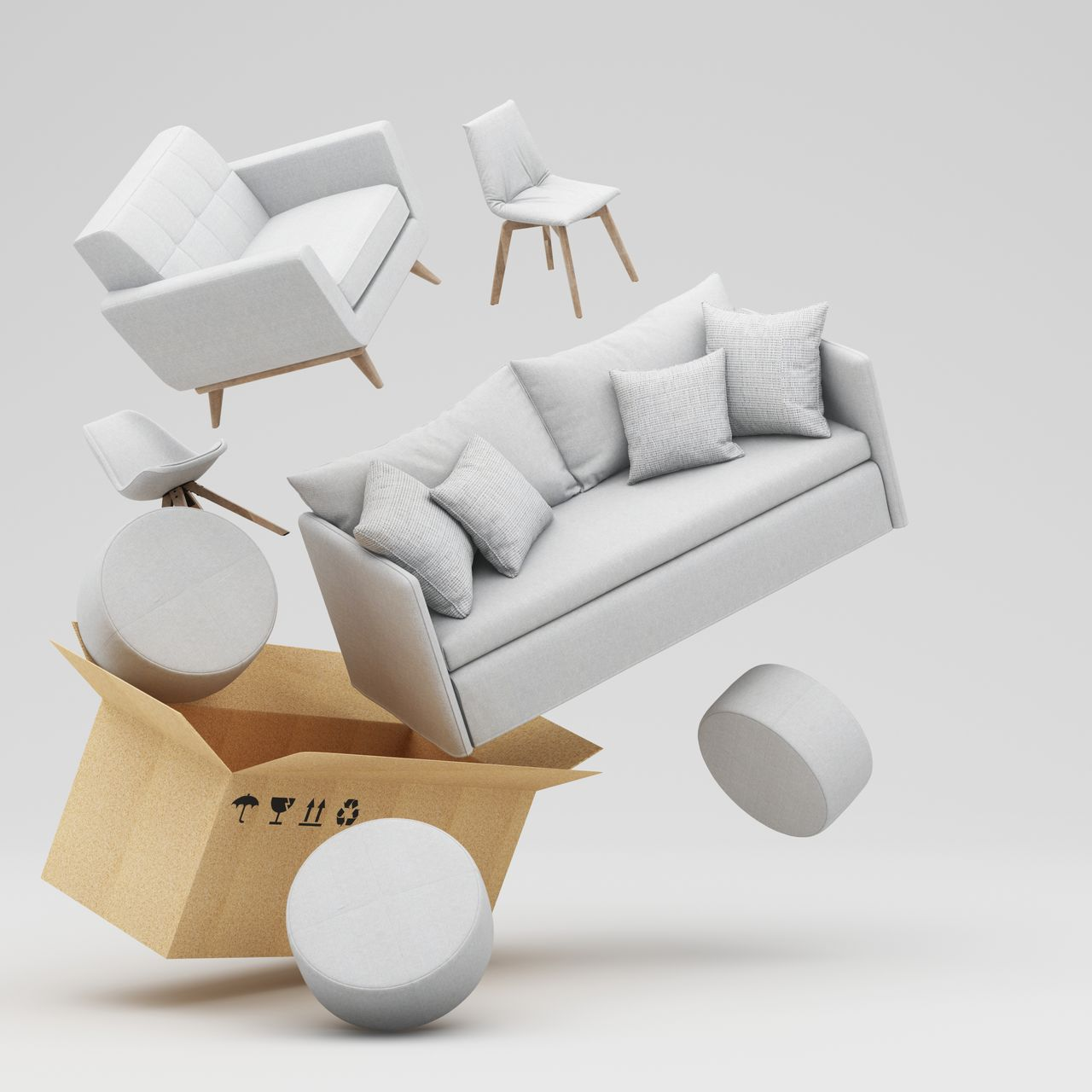 Des meubles blancs sortent d'un carton : canapé, chaises et poufs.