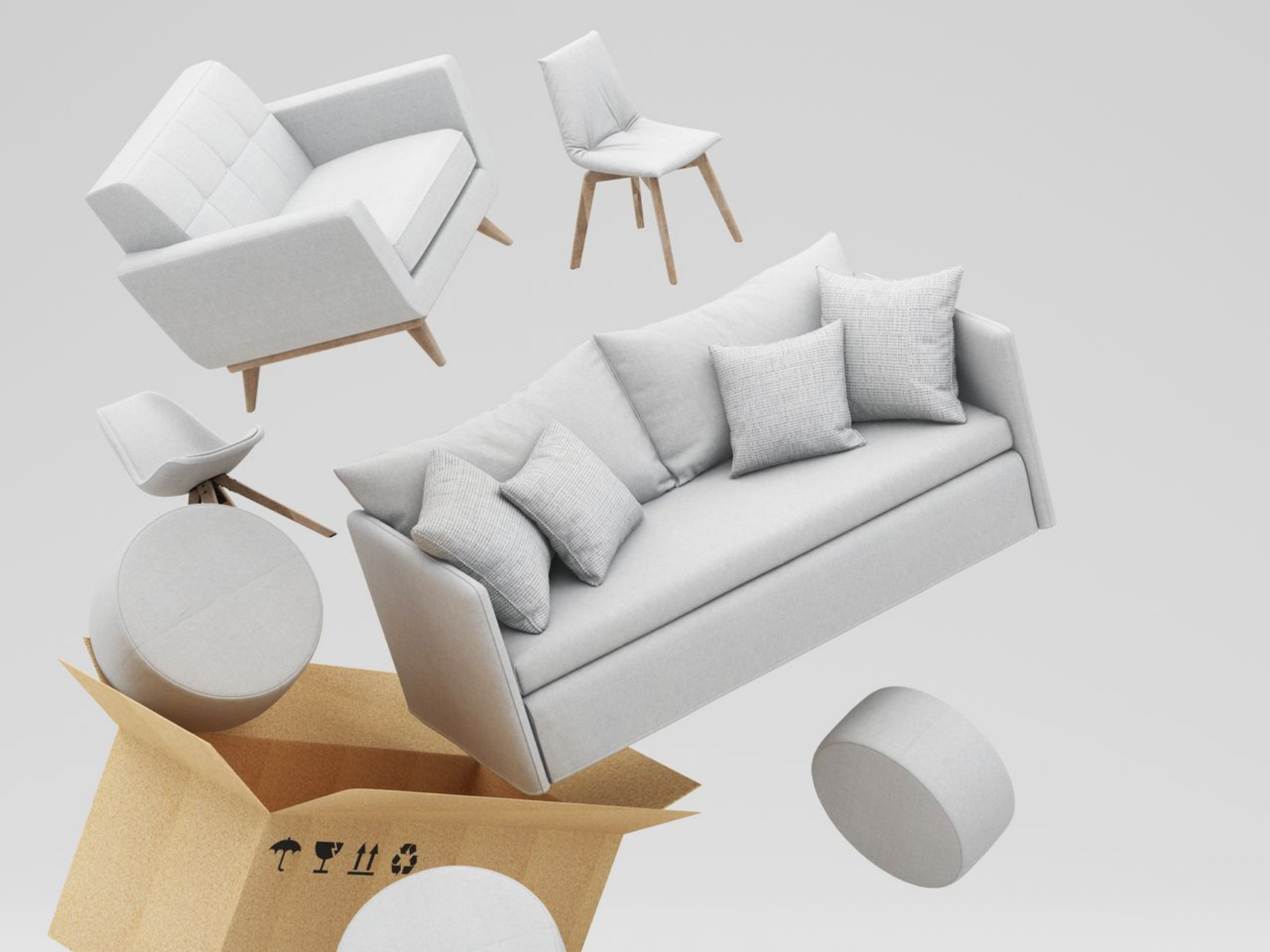 Des meubles blancs débordent d'une boîte en carton sur un fond gris.