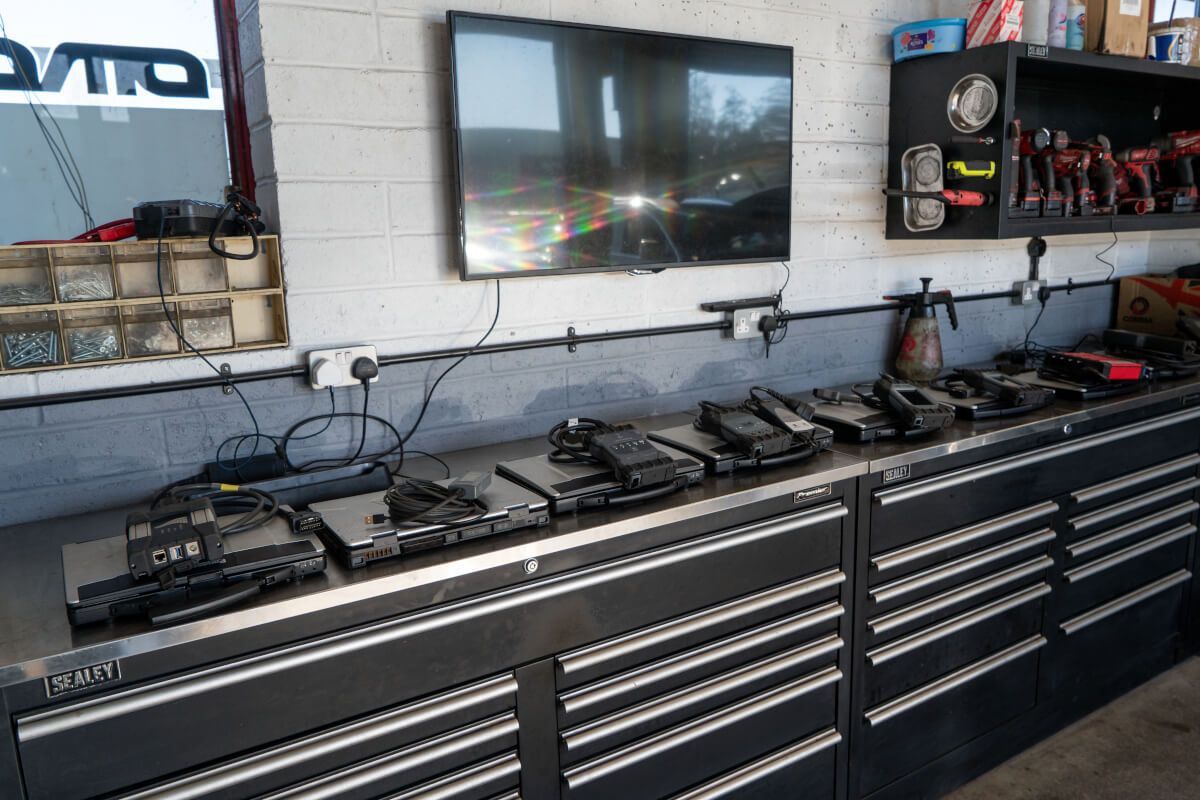 A garage with a lot of tools and a flat screen tv on the wall.