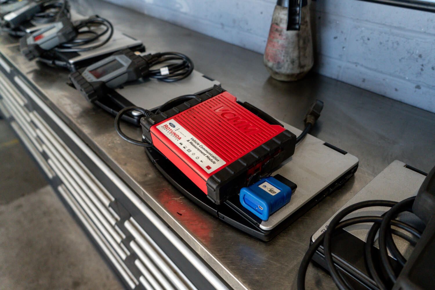 A red box is sitting on top of a laptop on a table.