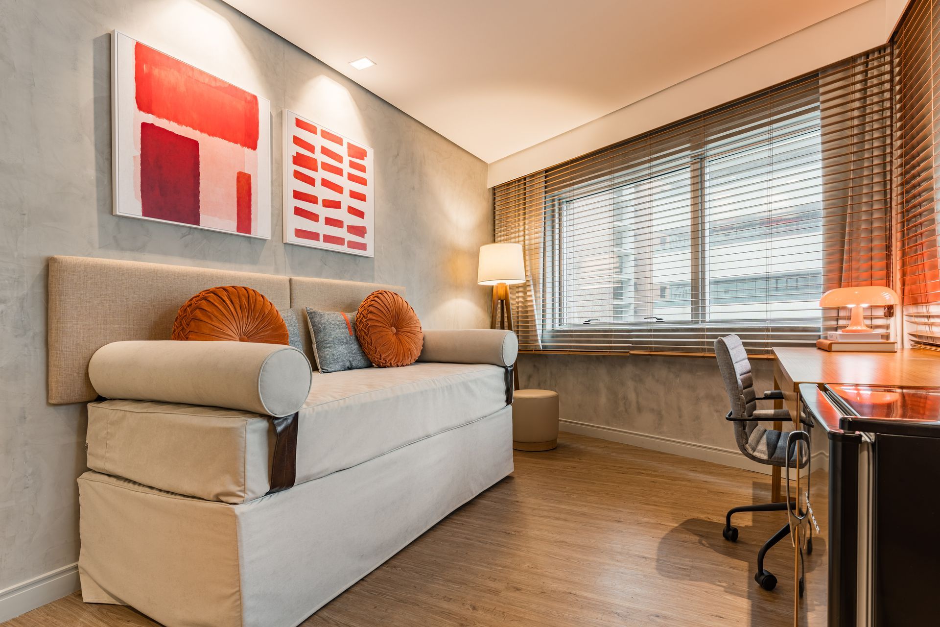 A living room with a couch and a desk
