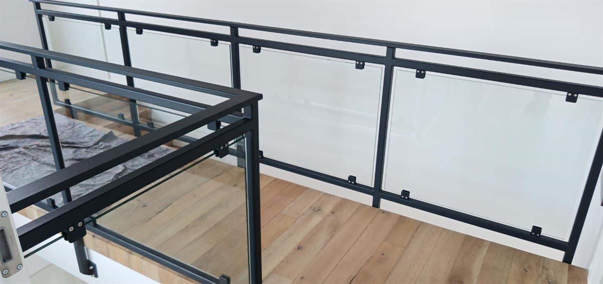 Eine Treppe mit schwarzem Geländer und Holzboden.