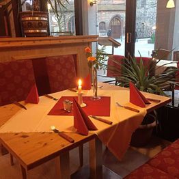 Innenansicht gedeckter Tisch für vier Personen am Fenster