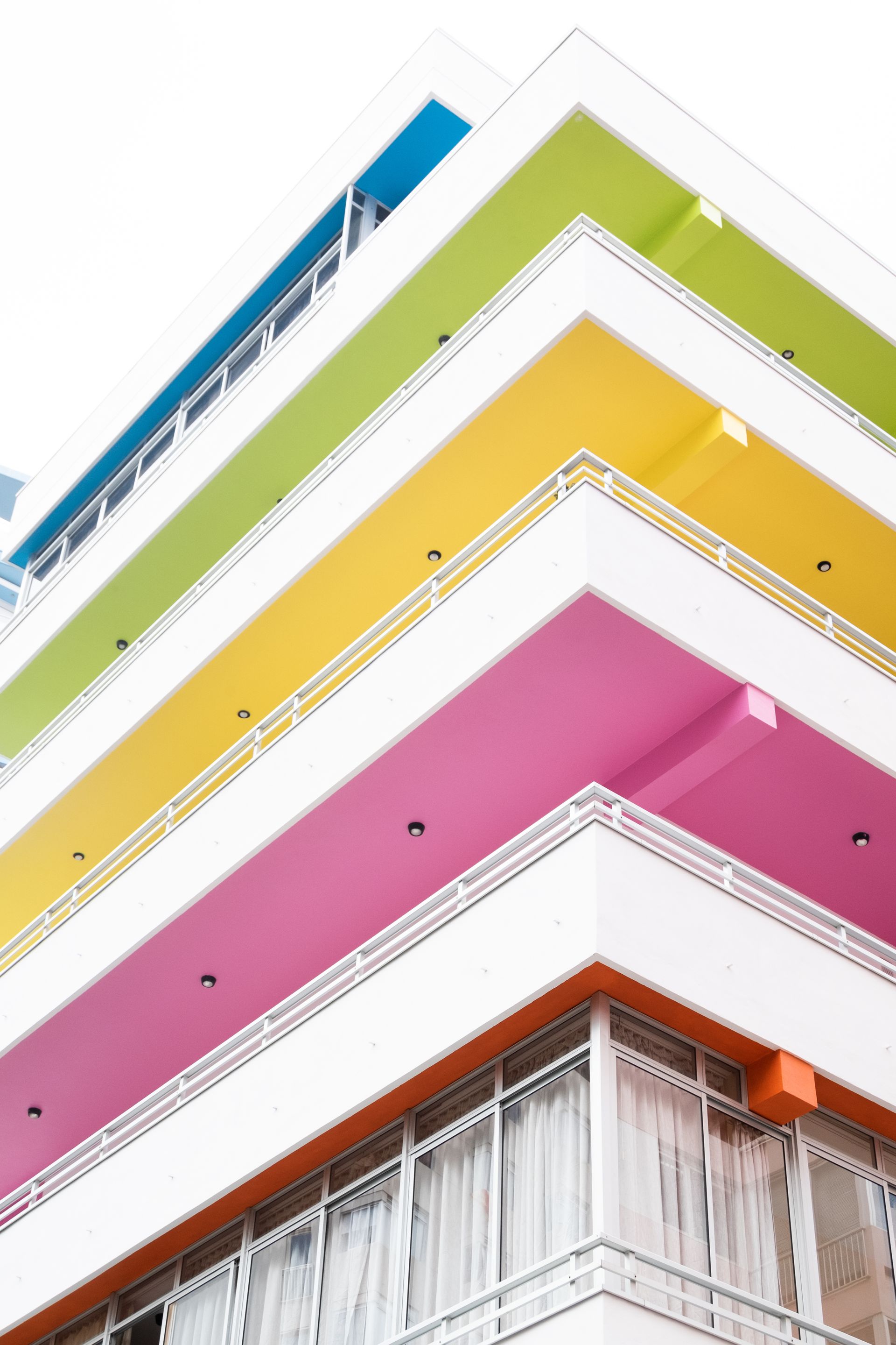 Un edificio con un arcoíris de colores en los balcones.