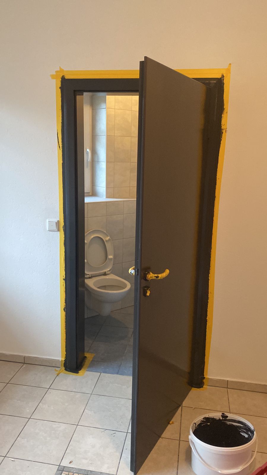 Ein Badezimmer mit Toilette und offener Tür