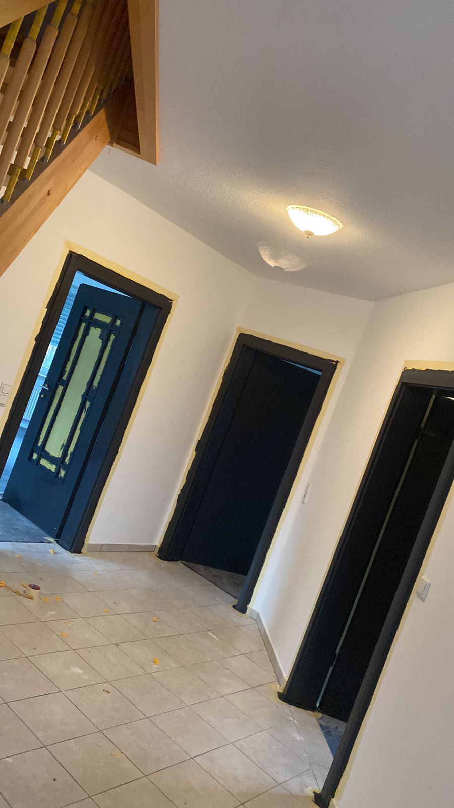 Ein Flur mit einer Treppe und einigen Türen