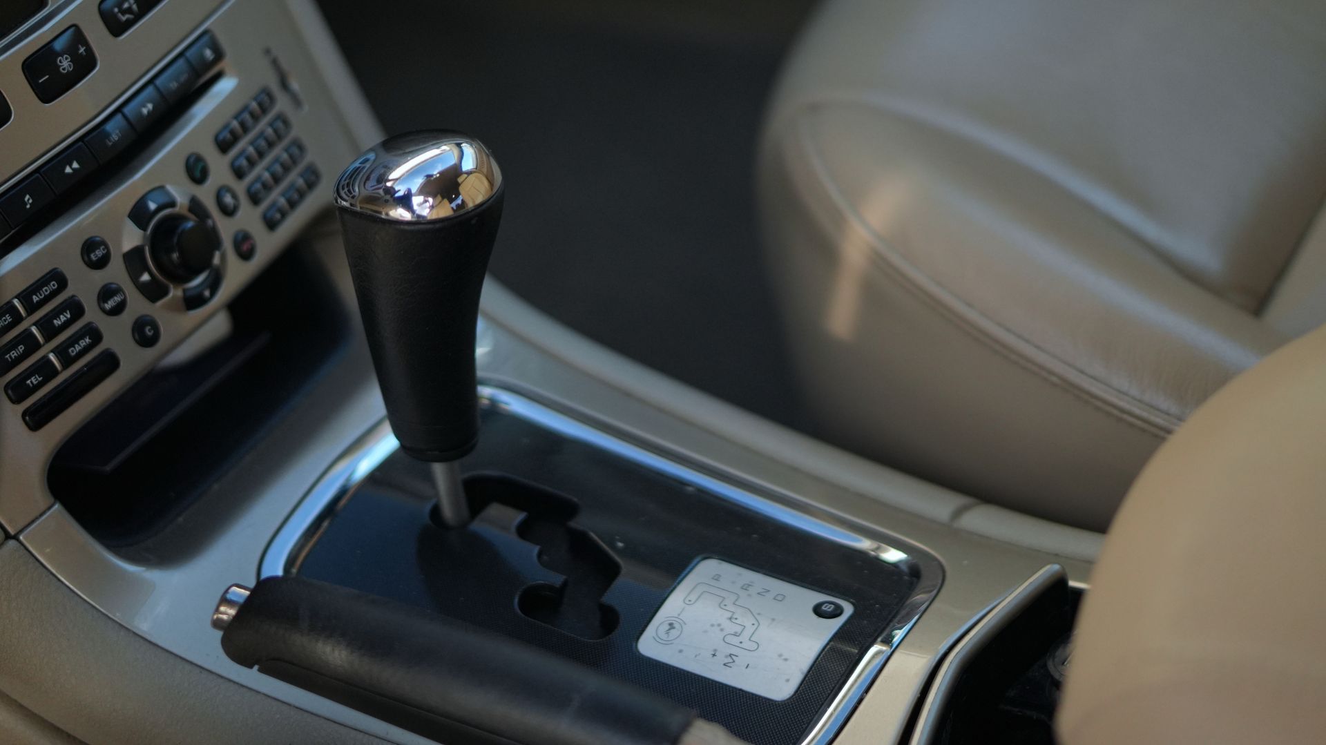 Gros plan du levier de vitesses automatique d'une voiture avec l'indicateur de vitesse allumé, indiquant « P » pour stationnement.