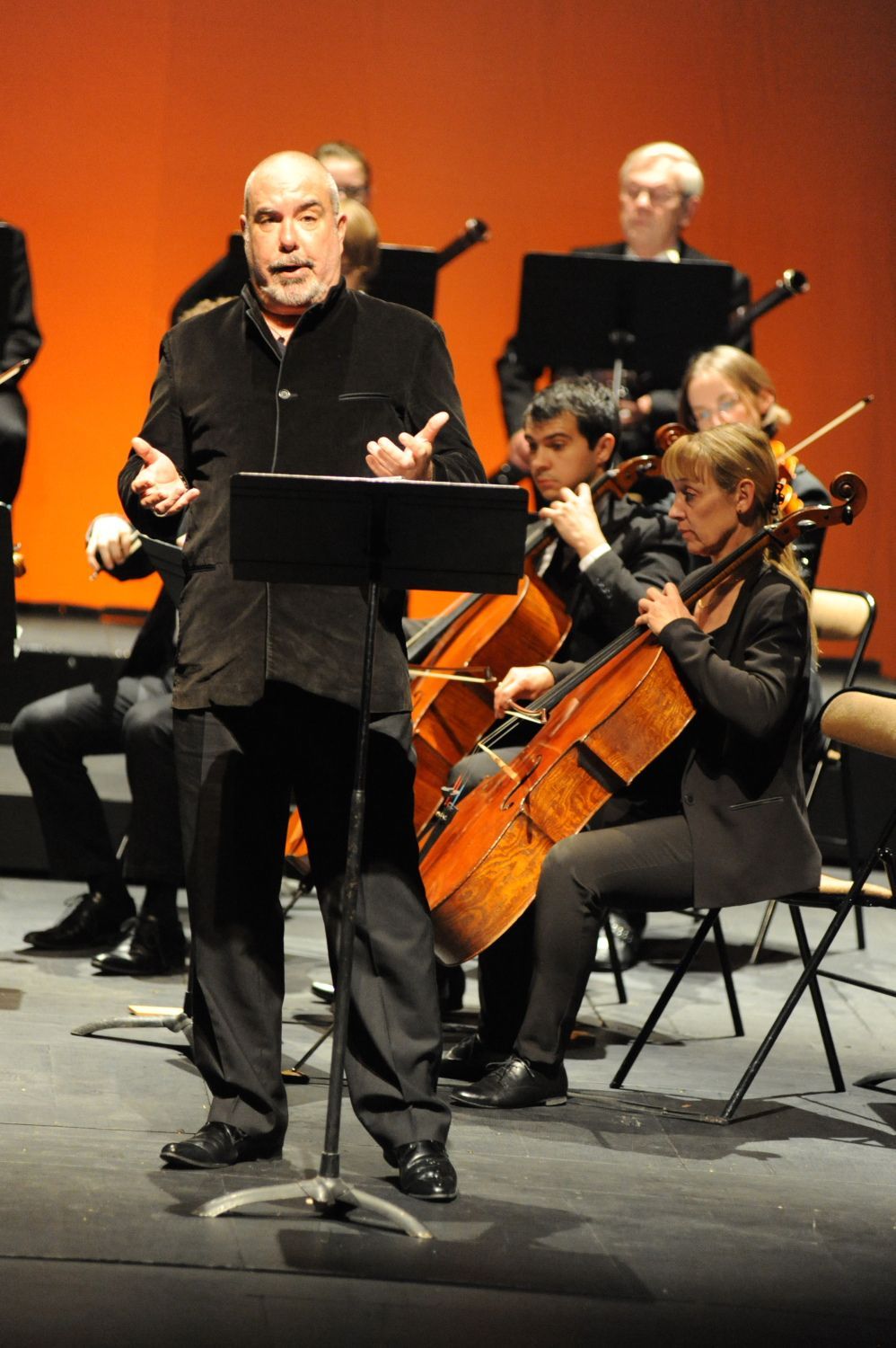 Homme chantant devant un orchestre de cordes