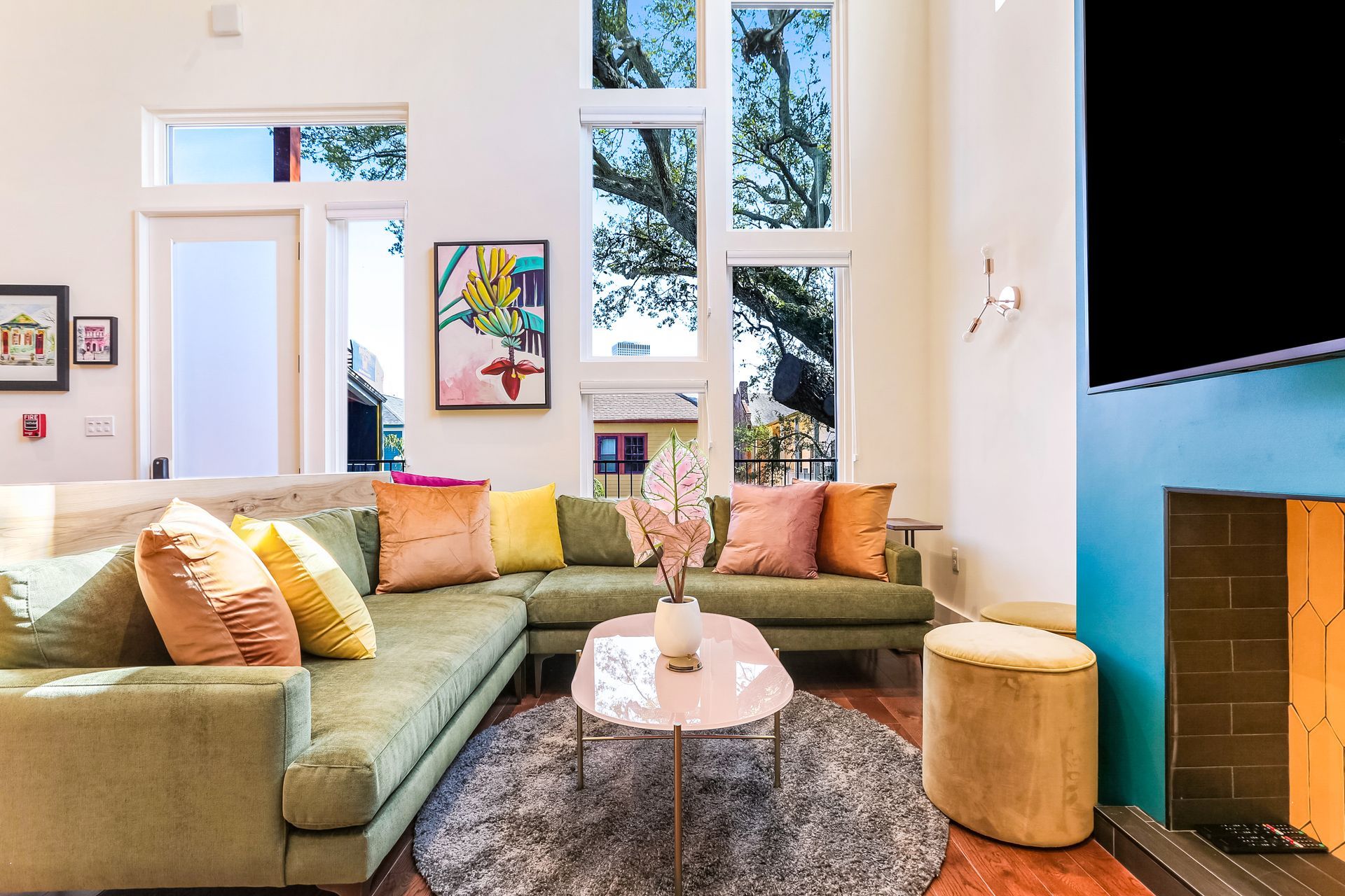 A living room with a couch , coffee table , fireplace and television.