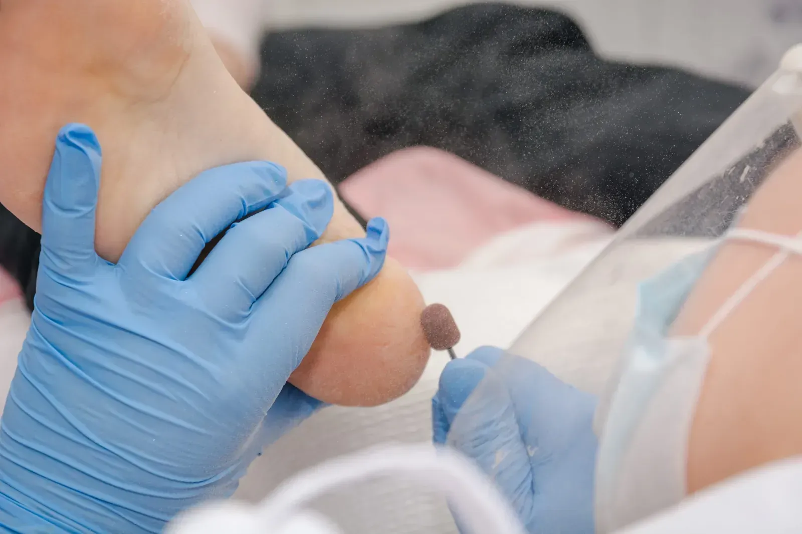 Una sala de exploración médica limpia y blanca con una camilla central