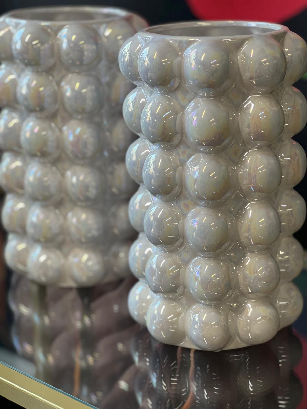 Ein paar Vasen auf einem Glastisch.