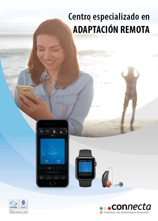 Una mujer está usando un teléfono inteligente y un reloj inteligente en la playa.