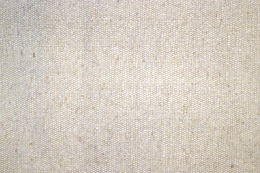 Eine Nahaufnahme eines Stückes Leinenstoff, die die Textur des Stoffes zeigt.