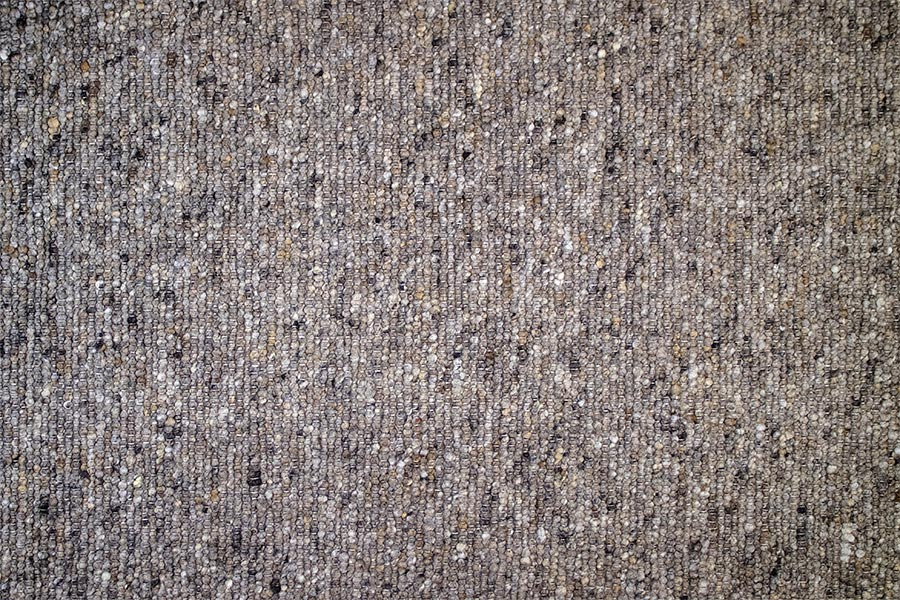 Eine Nahaufnahme einer grauen Teppichstruktur.