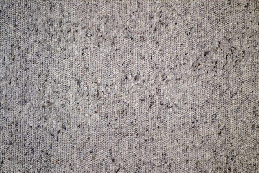 Eine Nahaufnahme einer grauen Teppichstruktur.