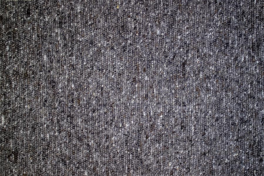 Eine Nahaufnahme einer grauen Teppichstruktur.