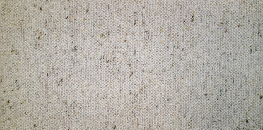 Eine Nahaufnahme eines weißen Teppichs mit vielen kleinen Punkten darauf.