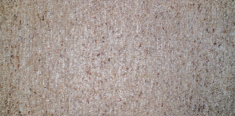 Eine Nahaufnahme eines Teppichs mit körniger Textur.