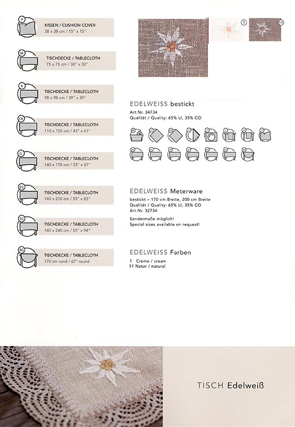 Auf einem Tisch liegt eine Tischdecke mit einer weißen Blume darauf.