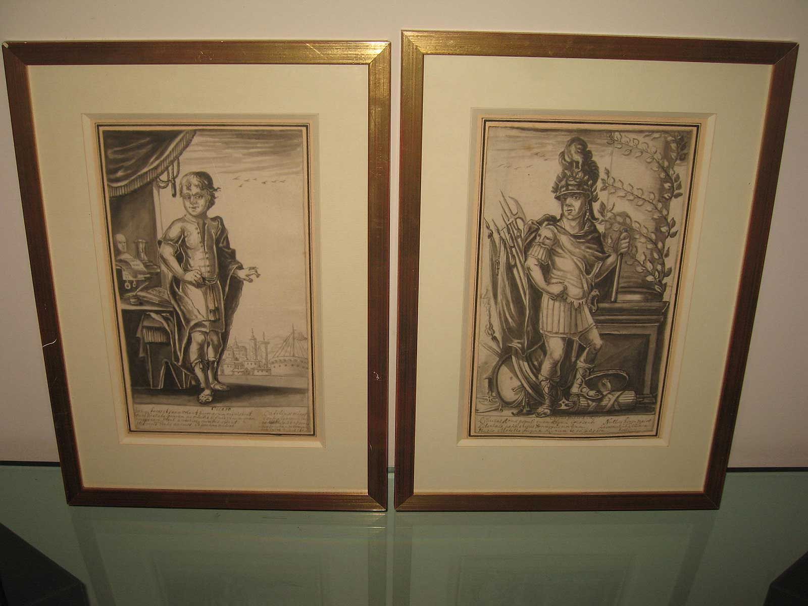 Deux gravures monochromes encadrées représentant des personnages en costumes classiques, placées côte à côte sur un fond uni.