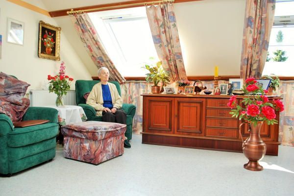 Eine Frau sitzt auf einem Stuhl in einem Wohnzimmer