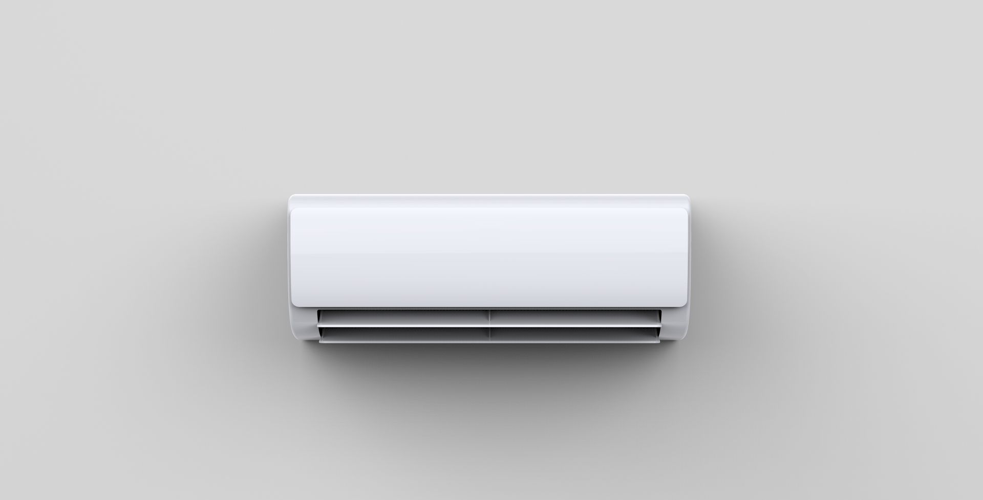 Climatiseur blanc fixé au mur sur un mur gris clair