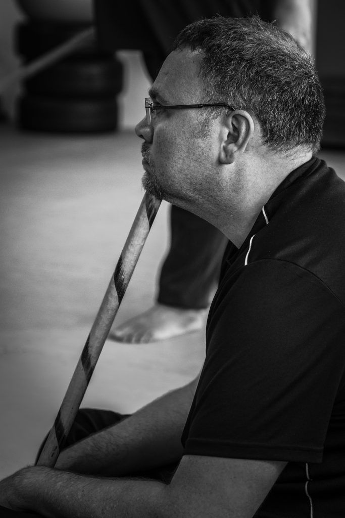 Zwei Kampftrainer und ein Schüler beim Üben auf der Matte