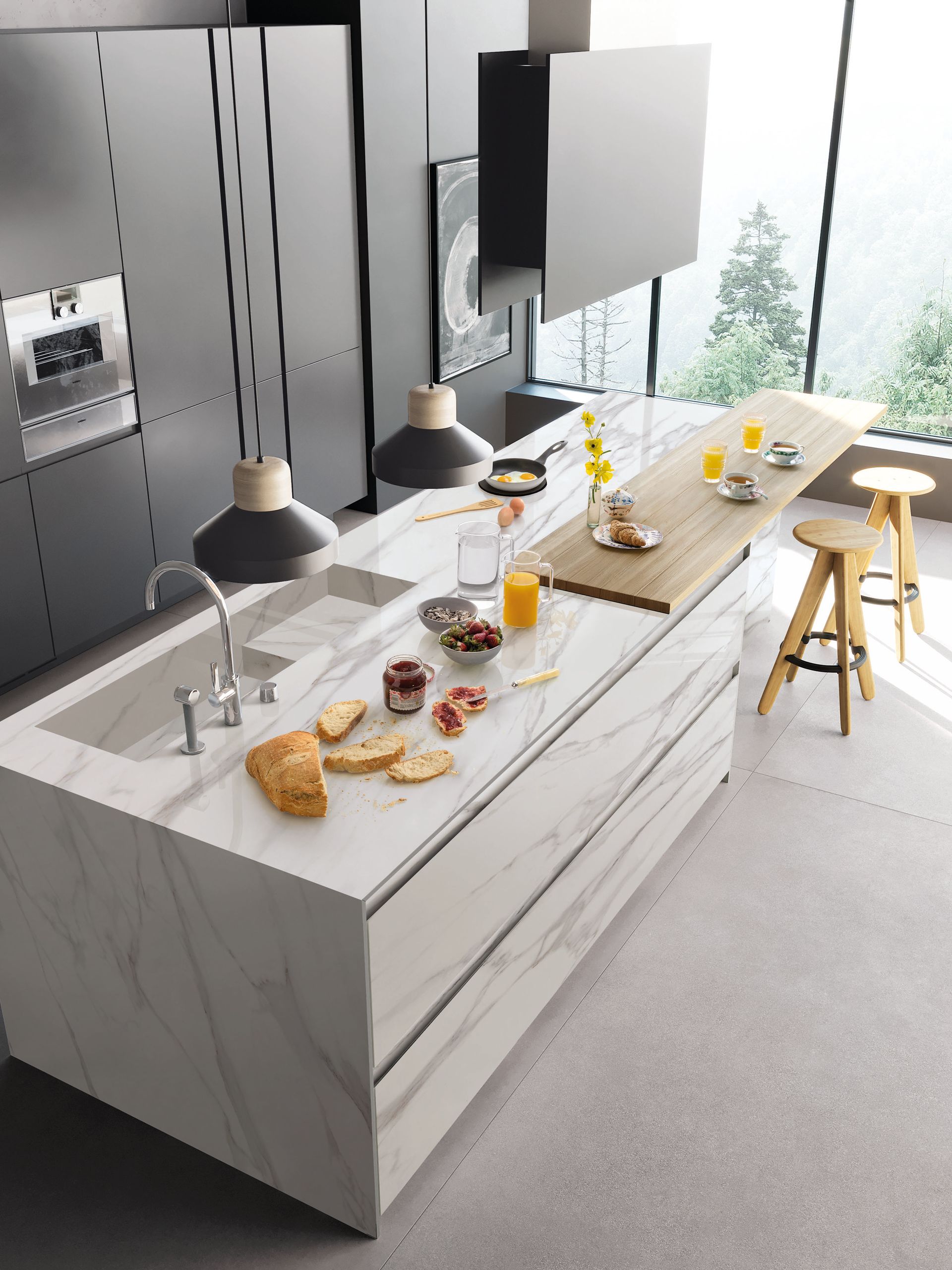 Îlot de cuisine moderne avec coin repas, suspensions lumineuses et tabourets près d'une fenêtre lumineuse