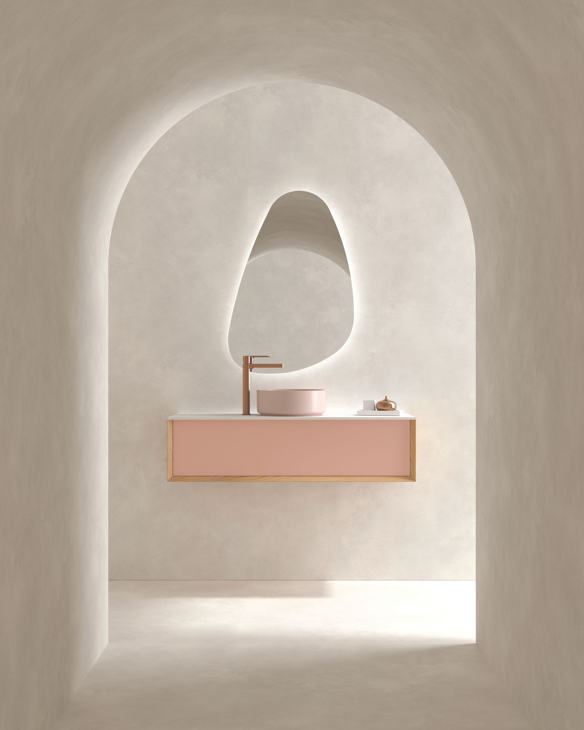 Meuble-lavabo minimaliste avec miroir arqué, meuble sous-lavabo rose et murs beige clair.