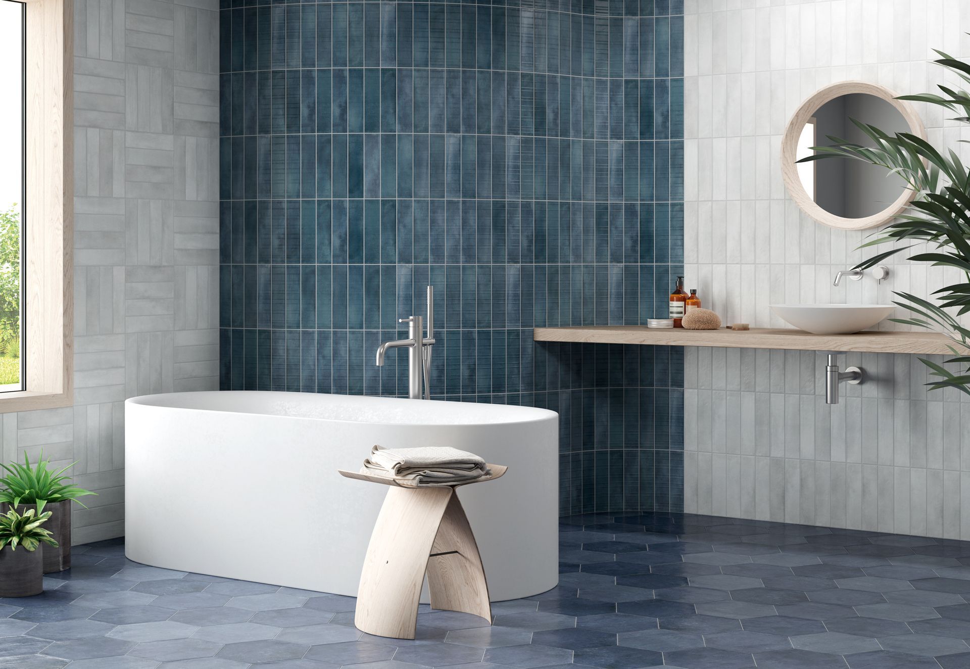 Salle de bains moderne avec baignoire blanche autoportante, mur carrelé de bleu, miroir rond et étagère de meuble-lavabo en bois