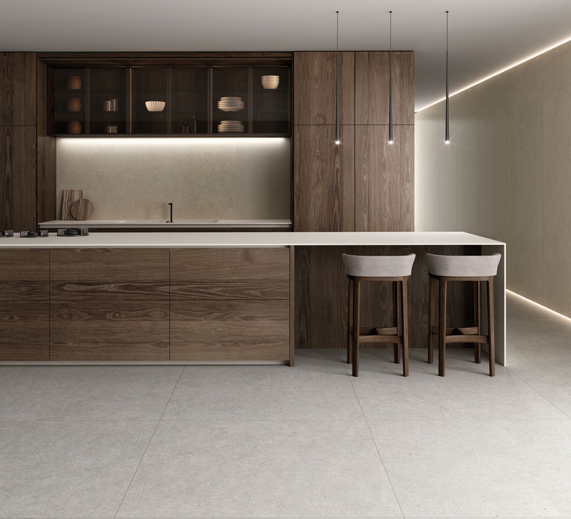 Cuisine moderne et minimaliste avec placards en bois, îlot central blanc et deux tabourets sous des suspensions lumineuses.