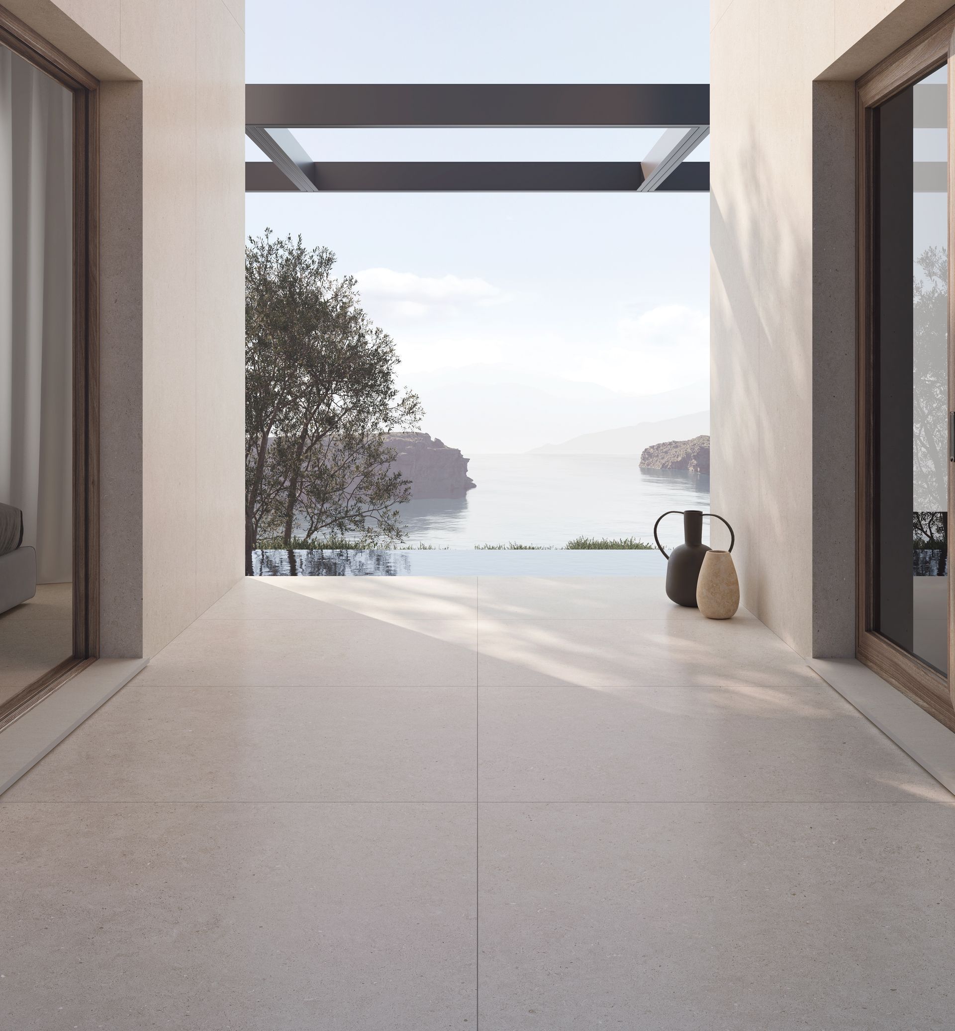 Terrasse minimaliste donnant sur une mer calme, encadrée par des murs blancs et un arbre, avec une petite chaise et un vase.