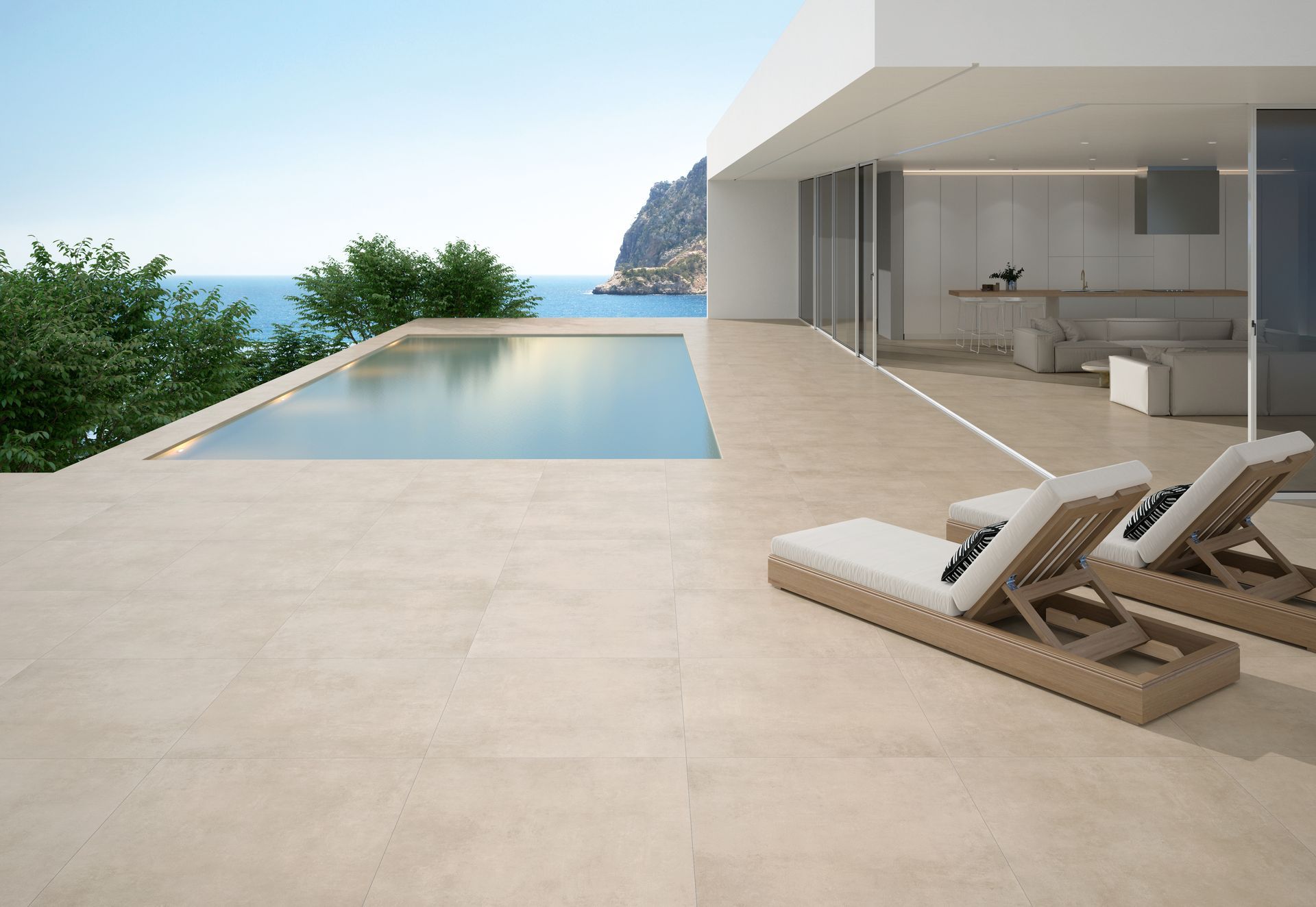 Terrasse moderne avec piscine à débordement, chaises longues et vue sur l'océan