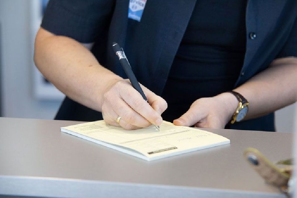 ATZ / Bosch-Car-Service Mitarbeiter schreibt einen Prüfbericht