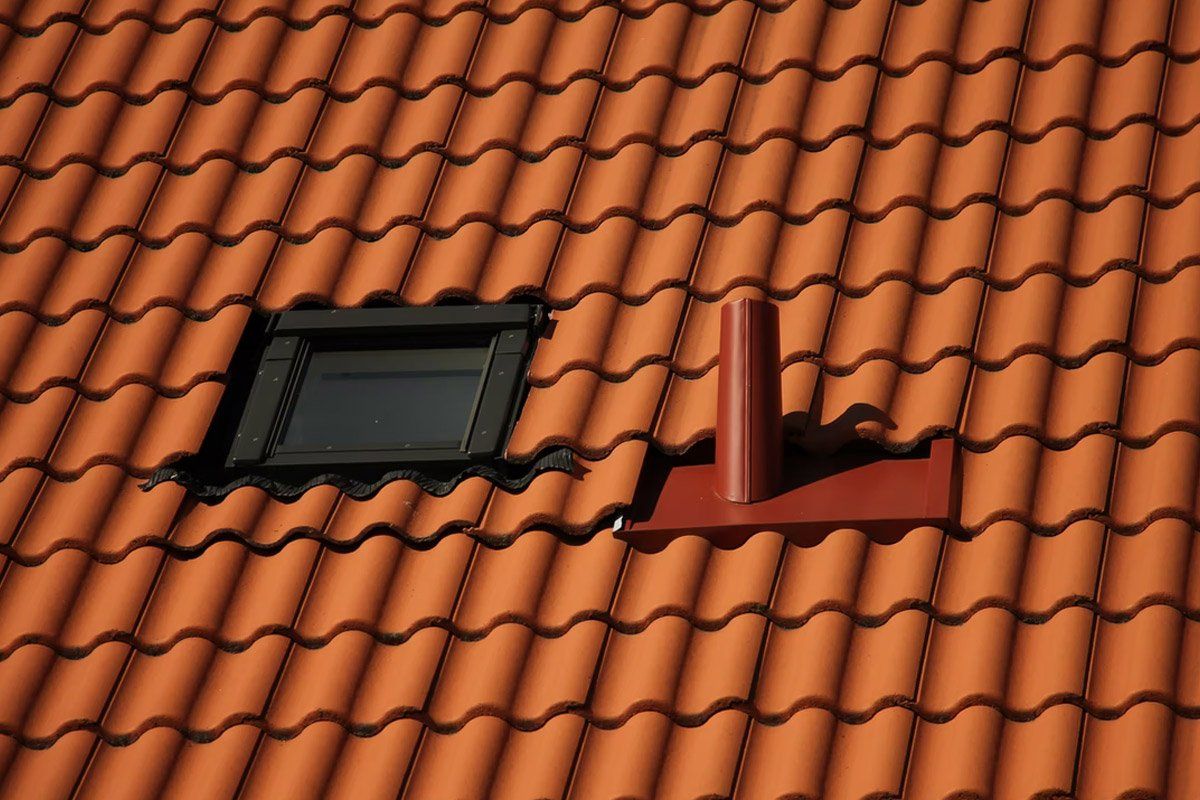 Toiture tuiles et Velux ainsi qu'une petite cheminée