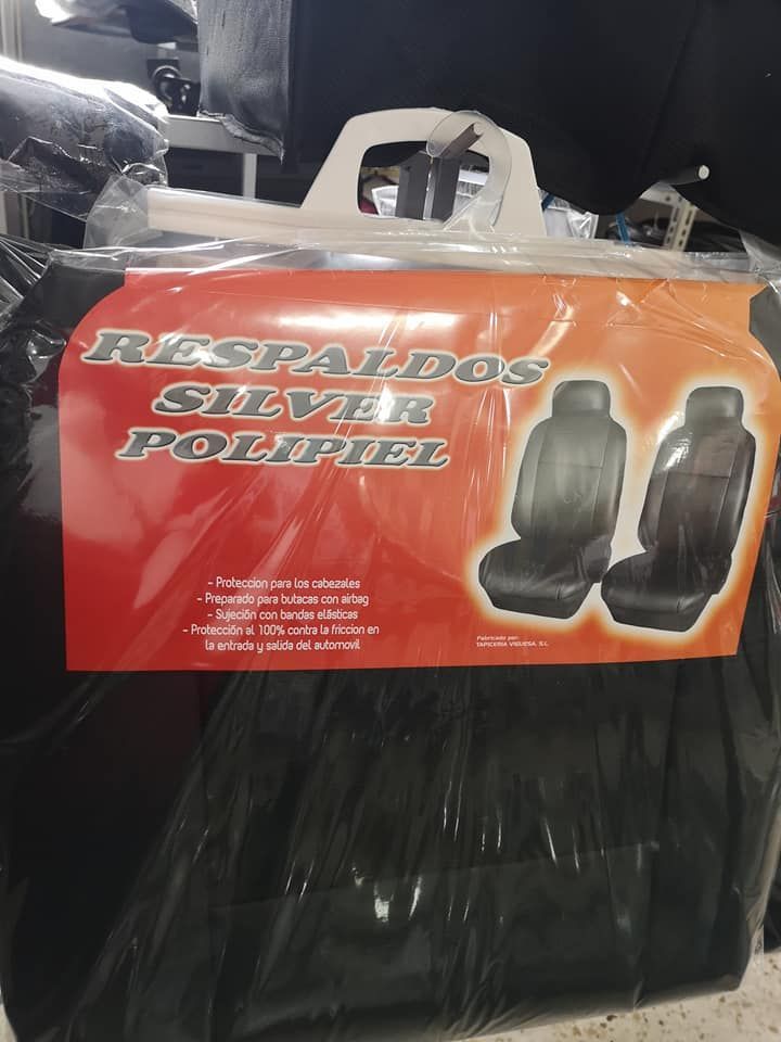 Un par de fundas de asiento negras en una bolsa que dice respaldos plata polipiel