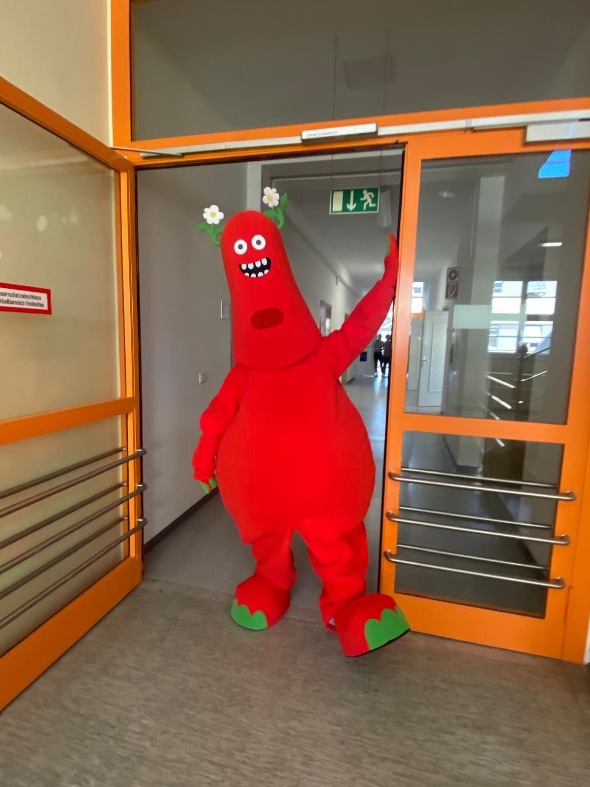Ein rotes Monster steht in einem orangefarbenen Türrahmen