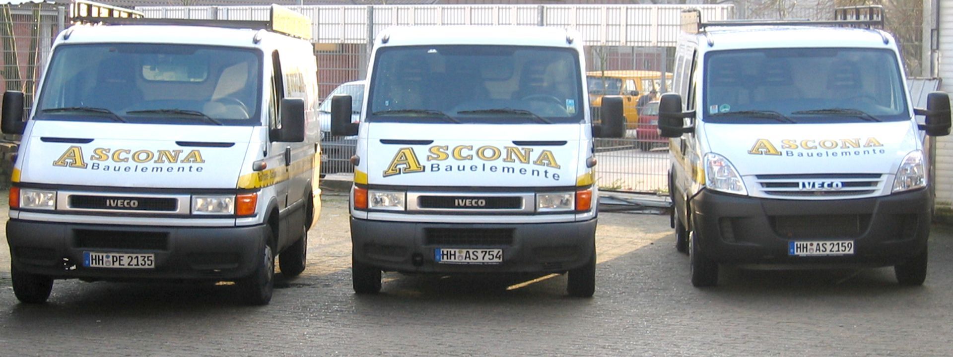 Drei weiße Lieferwagen parkten in einer Reihe, jeder mit dem „ASCONA“-Logo.