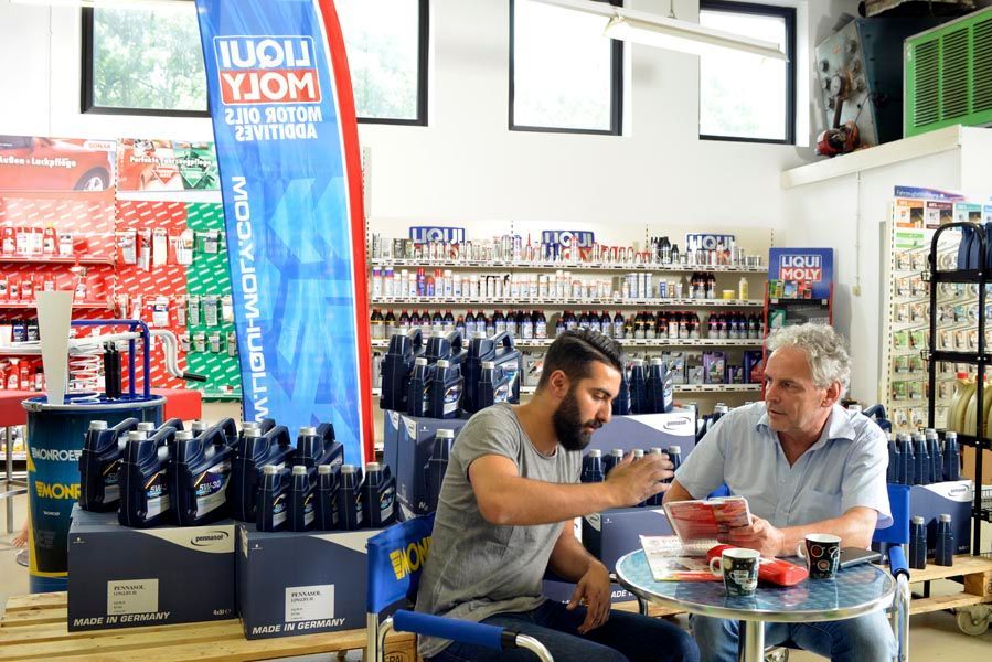 Zwei Personen unterhalten sich bei der PR-Autoteile Ladengeschäft in Lüdenscheid