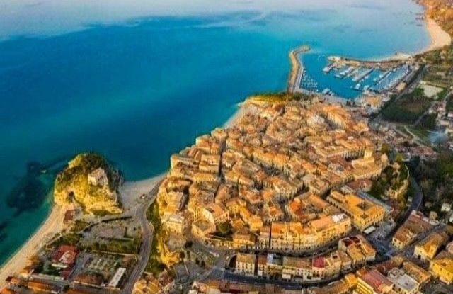 Eine Luftaufnahme einer Stadt neben einem Gewässer.