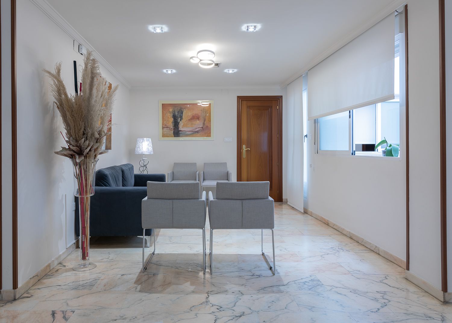 Una sala de estar con un sofá y sillas.